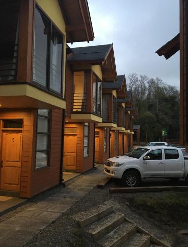 a white car parked in front of a row of houses at Loft Pucon in Pucón