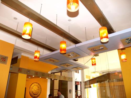 a group of lights hanging from the ceiling of a store at Intiqa Hotel in Puno