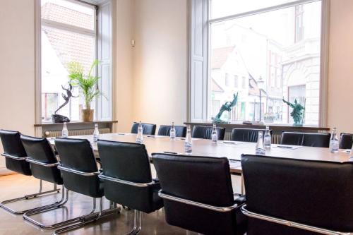 a conference room with a long table and chairs at Continental du Sud in Ystad