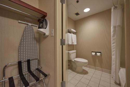 a bathroom with a toilet and a shower in it at Capital Hotel in St. John's