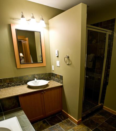 a bathroom with a sink and a shower at Pinnacle Ridge Chalets by Fernie Lodging Co in Fernie