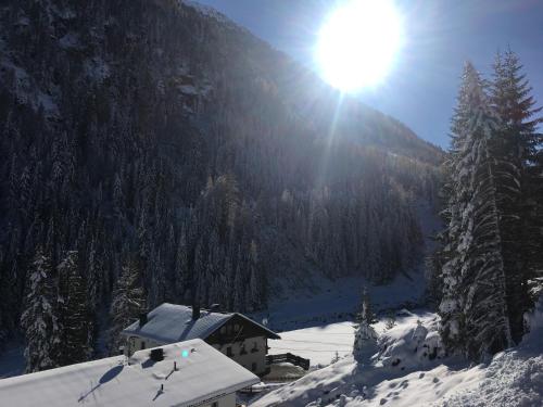 a snow covered mountain with a house in the foreground at Alpenspirit in Sölden