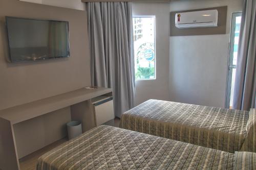 Hotel Gracher Praiaにあるベッド