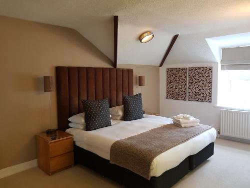 a bedroom with a large bed and a window at The Relish in Folkestone