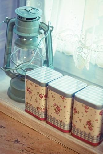 a group of three books on a shelf with a lantern at BB Boutique Hotel in Újlengyel