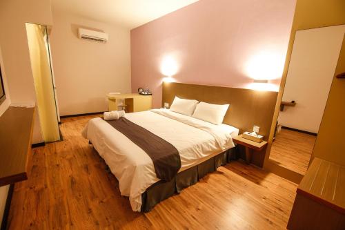a bedroom with a large bed in a room at Art Cottage Hotel in Ipoh