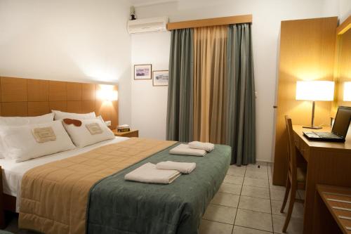 a hotel room with a bed with towels on it at Villa Contessa in Vasilikos
