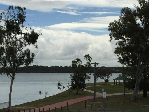a view of a body of water with trees at Bribie Waterways Motel in Bongaree