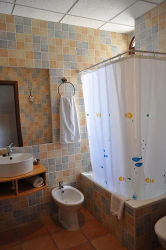 a bathroom with a shower and a sink and a toilet at Apartamentos Rurales Alcazaba de las Torres in Cañete de las Torres