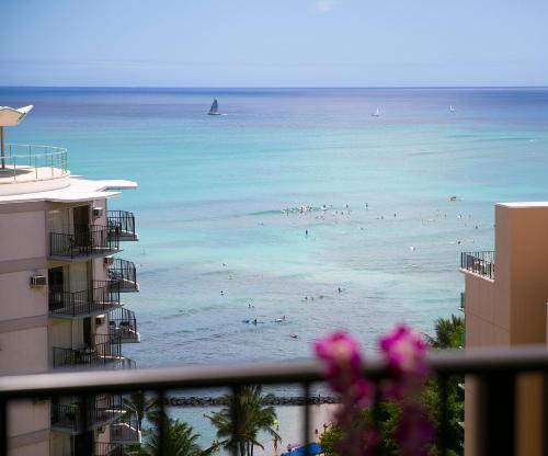 a view of a beach with people in the water at Waikiki Resort Hotel in Honolulu