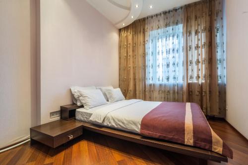 a bedroom with a bed and a large window at Lux near Most City with panoramic windows in Dnipro