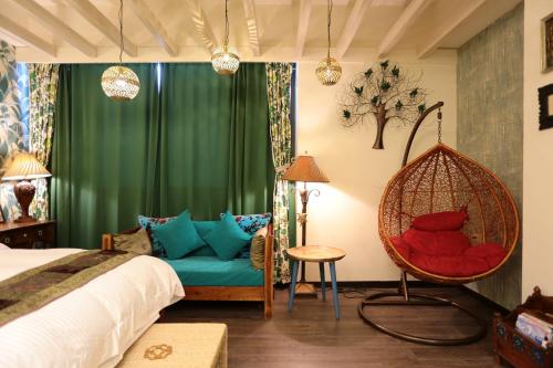 a bedroom with a bed and a hanging chair at Aria 2 Home (With Elevator) in Hualien City