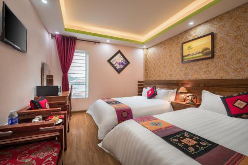 Postel nebo postele na pokoji v ubytování Sapa Luxury Hotel