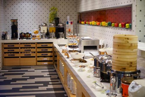 a kitchen with a counter with food on it at Beacon Hotel in Taichung