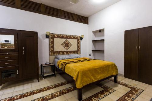 Ένα ή περισσότερα κρεβάτια σε δωμάτιο στο Merida Serviced Apartments