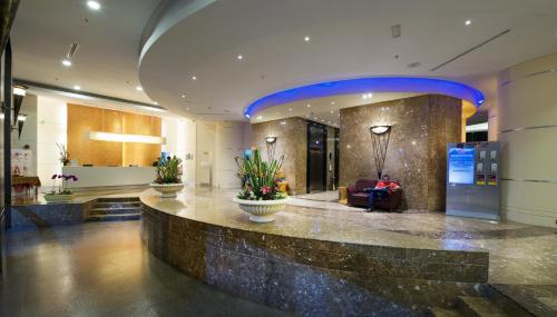 a lobby of a building with a large lobby at Hotel Royal Kuala Lumpur in Kuala Lumpur