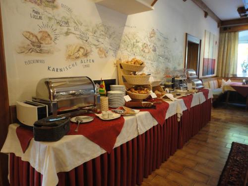 a buffet line in a restaurant with plates of food at Hotel Schloss Lerchenhof in Hermagor