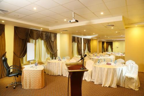 a conference room with tables with white tablecloths at Best Western Plus Salmiya in Kuwait