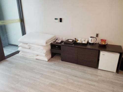 a room with a pile of towels and a counter at Hotel Wooyeon Flora in Boryeong