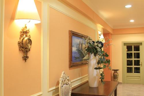 a vase with flowers on a table in a room at Balconata 2.0 Banqueting & Accommodations in Lucera