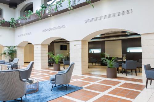 a lobby of a hotel with chairs and tables at Intelier Rosa in Castellón de la Plana