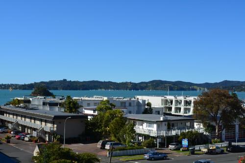 a view of a city with a river and buildings at Austria Motel in Paihia