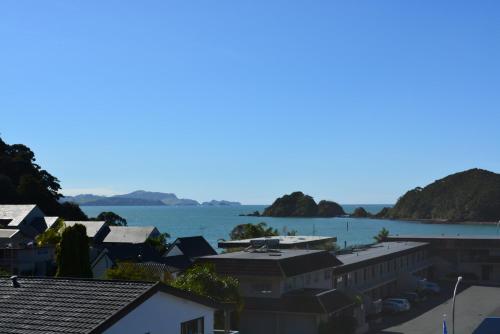 a view of a body of water with houses at Austria Motel in Paihia