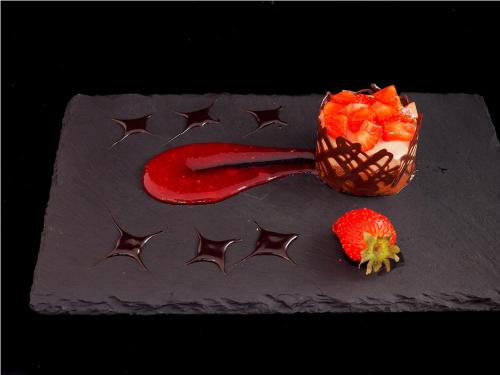 a chocolate cake with a strawberry and a number on it at Relais Santo Stefano in Sandigliano