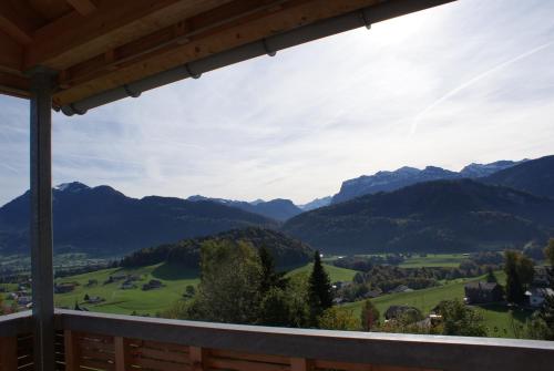 a view from the balcony of a house with mountains at Panoramahotel Sonnhalde in Schwarzenberg im Bregenzerwald