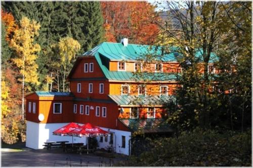 a large red building with a green roof at Hotel Alba in Deštné v Orlických horách