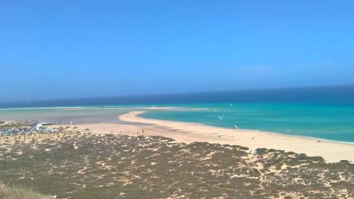 a view of a beach with people in the water at Your Ocean Suite in Costa Calma