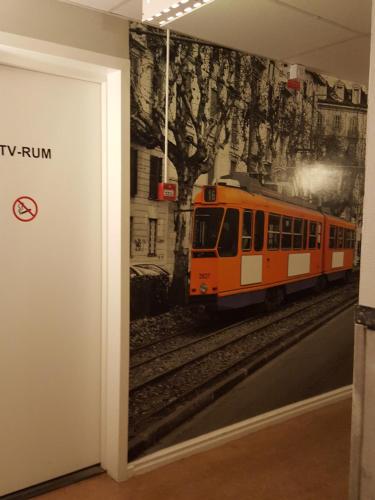 a mural of a train on a wall in a room at Centralstationens Vandrarhem in Norrköping