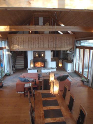 a large living room with a fireplace in a house at Gollitzalm in Harbach