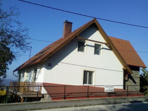 a white house with a brown roof at Jázmin Apartman in Tihany