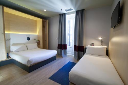 Ένα ή περισσότερα κρεβάτια σε δωμάτιο στο Toc Hostel Madrid