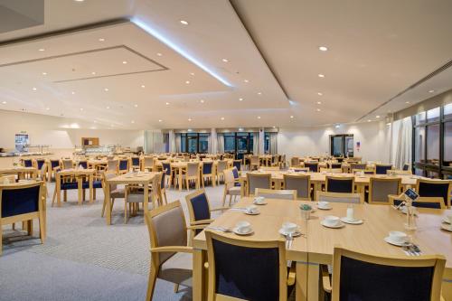 a large dining room with tables and chairs at Warwick Conferences - Radcliffe in Coventry