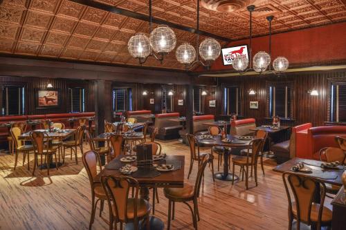 a restaurant with tables and chairs and a bar at The Madison Hotel in Morristown