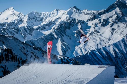 a man riding a snowboard on a ramp in the snow at XL Appartements Sand in Taufers in Campo Tures