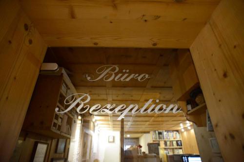 a store with a sign that reads fuze reception at Biobauernhof Gehrnerhof am Arlberg in Warth am Arlberg