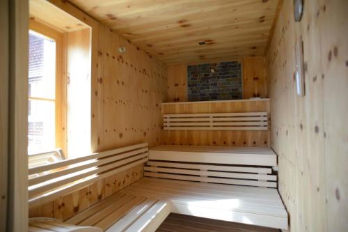 a sauna with wooden walls and a window at Biobauernhof Gehrnerhof am Arlberg in Warth am Arlberg
