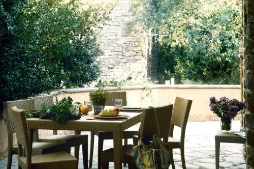 a table and chairs on a patio at Roccamare Resort - Ville e Appartamenti in Castiglione della Pescaia
