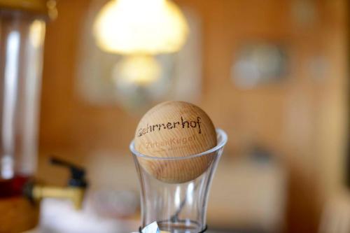a wooden egg sitting in a glass cup at Biobauernhof Gehrnerhof am Arlberg in Warth am Arlberg