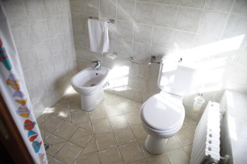 a bathroom with a toilet and a bidet at Agriturismo Da Nonna Argia in Massa e Cozzile