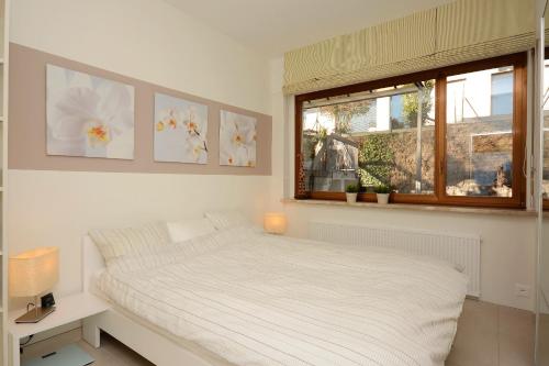 Un pat sau paturi într-o cameră la Collina d'Oro