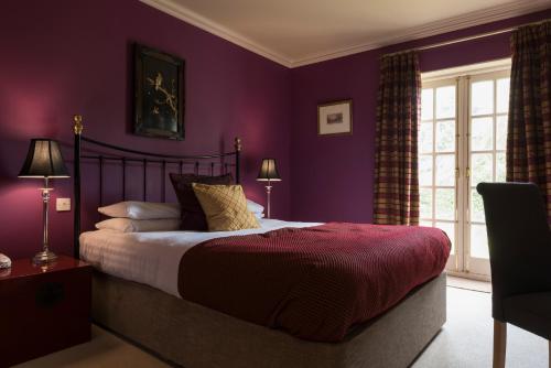 A bed or beds in a room at Knockomie Hotel 