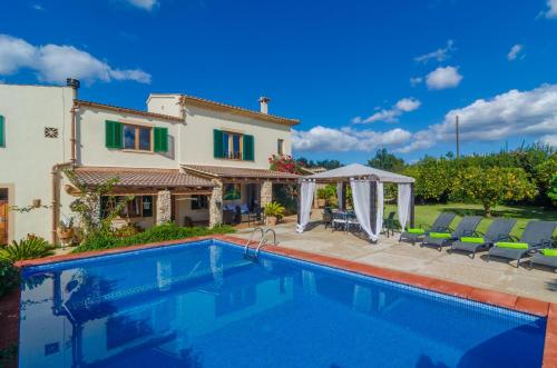 a villa with a swimming pool and a house at Can Rius in Muro