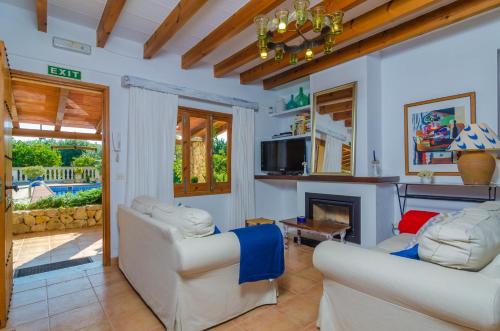 a living room with two couches and a fireplace at Can Rius in Muro