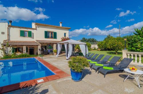 a villa with a swimming pool and a house at Can Rius in Muro