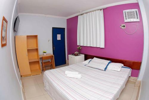 Ένα ή περισσότερα κρεβάτια σε δωμάτιο στο Pousada Ferreira