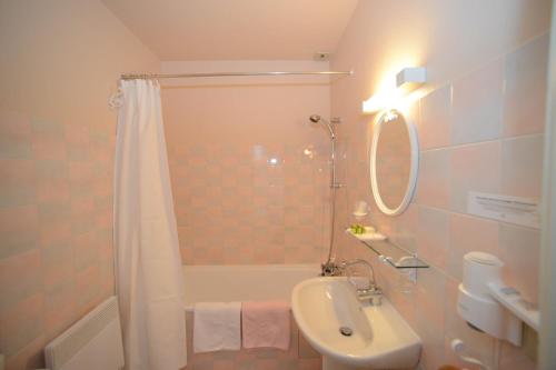 a bathroom with a tub and a sink and a shower at Logis Hôtel Restaurant Manoir De L'Acherie in Sainte-Cécile